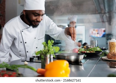 Skilled gastronomy expert garnishing gourmet dish with parmesan cheese in restaurant professional kitchen. Cuisine chef preparing food using fresh herbs and organic vegetables. - Powered by Shutterstock