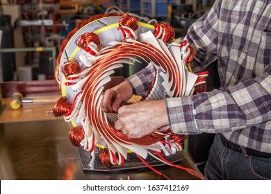 Skilled Industrial Worker Assembling A Large Electric Motor