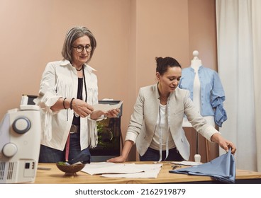 Skilled inspired creative team of female fashion designers tailors creates clothes for new seasonal collection, discussing sewing patterns and fabric in a fashion design workshop and tailoring atelier - Powered by Shutterstock