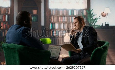 Skilled intelligence agent on a secure landline phone call discussing confidential information and doing background check on a suspect. Untraceable disposable number in espionage. Camera A.