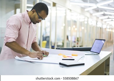 Skilled Male Student Working On University Coursework Making Sketching And Measures For Project While Creating Online Map On Laptop Computer With Mock Up Monitor Connected To Fast 5G Wireless 