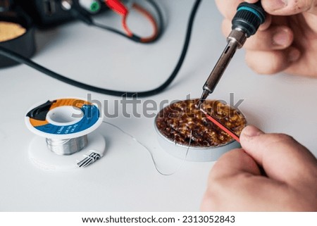 Skilled Man Hands Soldering Electronics