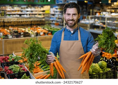 A skilled mature male employee in a supermarket stands proudly in the produce section, with a variety of fresh vegetables surrounding him, signaling quality and freshness. - Powered by Shutterstock