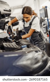 A skilled mechanic is focused on the complex task of repairing a car engine in a professional workshop
