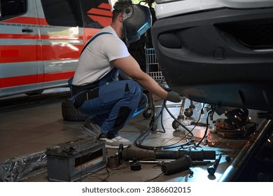 Skilled mechanic performing client automobile repair in workshop - Powered by Shutterstock