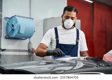 Skilled mechanic working on a car, wearing protective gear and focused. - Powered by Shutterstock