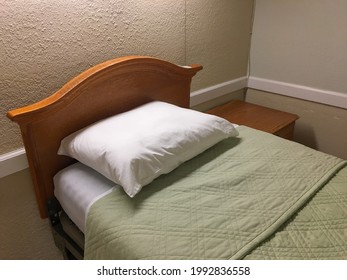 Skilled Nursing Facility Bed With Green Linens.