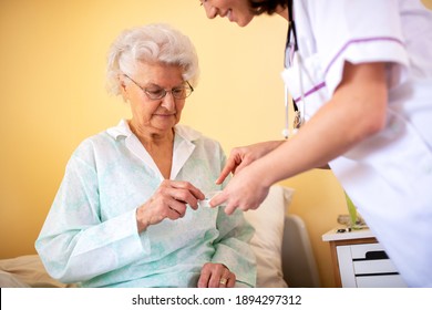 Skilled Nursing Facility Doctor Explaining To Senior Woman Occupant Which Medications She Should Be Taking For Prescribed Therapy