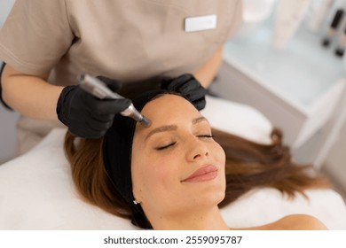 A skilled practitioner performs microneedling on a relaxed client, enhancing skin texture and rejuvenation. The tranquil spa ambiance promotes a sense of calm and well-being.