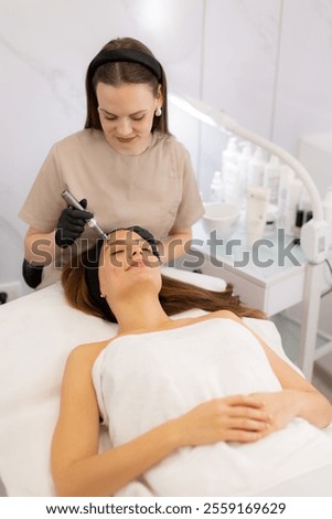 A skilled practitioner performs microneedling on a relaxed client, enhancing skin texture and rejuvenation. The tranquil spa ambiance promotes a sense of calm and well-being.