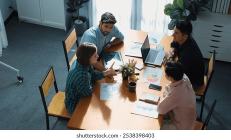 Skilled project manager walking at table while colleague brainstorm idea. Business team working together to plan marketing strategy while looking at data analysis or financial statistic. Convocation. - Powered by Shutterstock