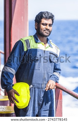 Skilled ship engineer on the deck of a merchant vessel, international logistics and shipping industry theme.