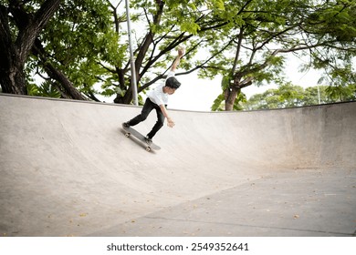 A skilled skateboarder performs tricks in a smooth, expansive concrete bowl designed for skating - Powered by Shutterstock