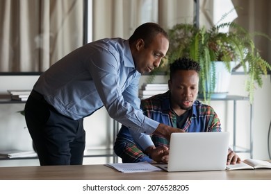 Skilled Smart Middle Aged African Ethnicity Leader Ceo Executive Manager Coaching New Employee, Explaining Corporate Computer Software Applications In Modern Office, Cooperation Concept.