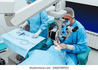 Skilled surgeon and his medical team performs precise eye surgery on an elderly patient, restoring vision with latest medical technology and cutting-edge techniques. Modern eye surgery concept. - Powered by Shutterstock