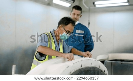 Skilled technician who paints cars by using masking tape on areas that do not want to be painted. Prevent the paint from sticking to that area Convenient when spraying new paint. in a car repair shop