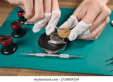 A skilled watchmaker assembles a luxury mechanical watch movement using fine tools and attention to detail on a clean workbench.