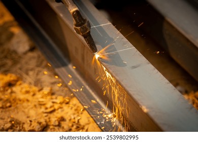 Skilled welder cuts metal with a gas torch in industrial workshop. Sparks fly during precision fabrication process. Craftsman control and expertise in metalworking. Gas torch cuts through steel. - Powered by Shutterstock