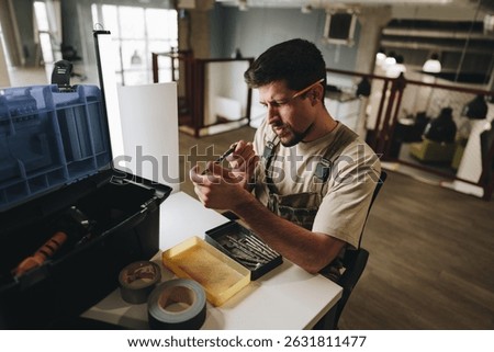 Skilled worker organizes tools while preparing for repairs in a modern office environment