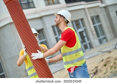 Skilled Workers Carrying Out A Residential Sewer Line Installation