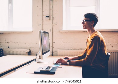 Skilled young male IT developer watching video online testing application installing during working process, professional skilled programmer updating software on modern computer sitting in office - Shutterstock ID 749045011