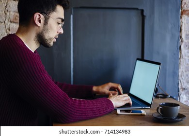 Skilled Young IT Professional Writing Email For Customer During Programming New Useful Web Application On Laptop Computer With Blank Screen For Your Promotional Content While Working Remotely