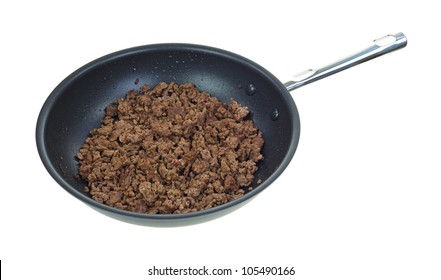 A skillet with a large portion of cooked ground beef on a white background.