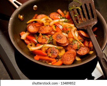 Skillet Of Sausage And Red Bell Peppers On The Stove