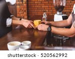 Skillful bartender serving client in coffeehouse