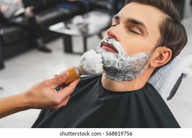 Skillful beautician preparing to shave stubble - Powered by Shutterstock