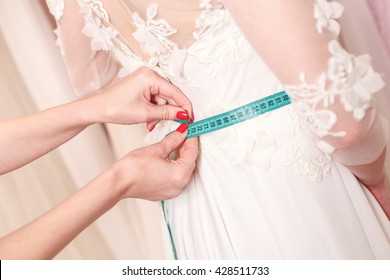 Skillful Designer Fitting Bridal Gown To Girl