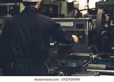 Skillful factory engineer or worker do machine job in manufacturing workshop . Industrial people and manufacturing labor concept .