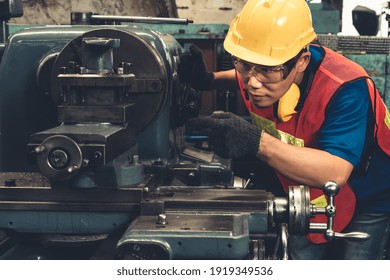 Skillful Factory Worker Or Engineer Do Machine Job In Manufacturing Workshop . Industrial People And Manufacturing Labor Concept .