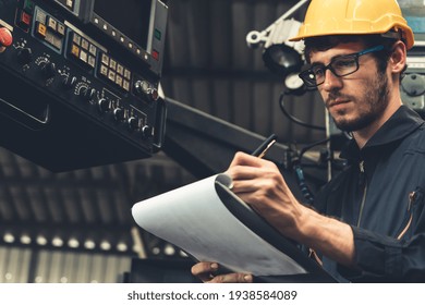 Skillful Factory Worker Working With Clipboard To Do Job Procedure Checklist . Factory Production Line Occupation Quality Control Concept .