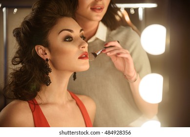 Skillful Makeup Artist Applying Powder On Model's Face