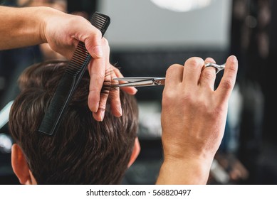 Skillful Male Barber Doing Haircut