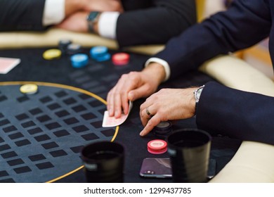 Skillful Man Playing Poker, Looking At His Stud And Thinking Of A Strategy. Professional Gambler In A Casino.