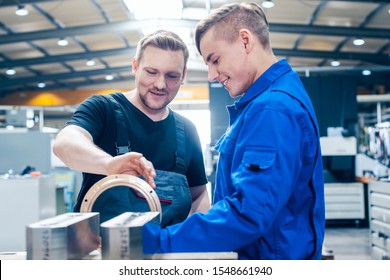 Skillful Master Discussing A Workpiece With His Apprentice Or Trainee