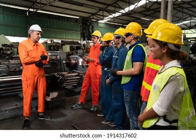 Skillful Worker Attending Brief Meeting In The Factory . Industrial People And Manufacturing Labor Concept .