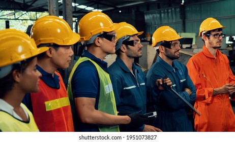 Skillful worker attending brief meeting in the factory . Industrial people and manufacturing labor concept . - Shutterstock ID 1951073827