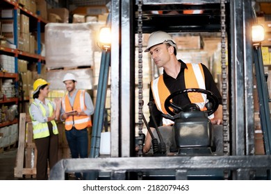 Skillful worker drives forklift in the factory .men labor worker at forklift driver position with safety suit and helmet happy smile enjoy working in industry factory logistic shipping warehouse. - Powered by Shutterstock