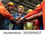 Skillful worker stand together showing teamwork in the factory . Industrial people and manufacturing labor concept .