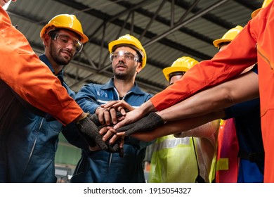 Skillful worker stand together showing teamwork in the factory . Industrial people and manufacturing labor concept . - Shutterstock ID 1915054327