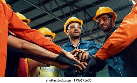 Skillful worker stand together showing teamwork in the factory . Industrial people and manufacturing labor concept . - Shutterstock ID 1936171636