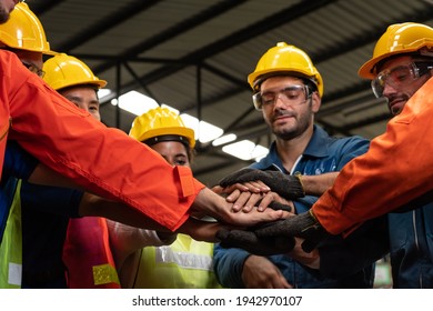 Skillful worker stand together showing teamwork in the factory . Industrial people and manufacturing labor concept . - Shutterstock ID 1942970107
