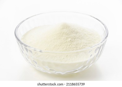 Skim Milk Powder In Glass Bowl On White Background