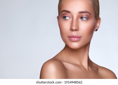 Skin beauty healthy beautiful Hair woman face close up pure skin natural makeup. Beautiful young blonde girl isolated on gray background, look to the side