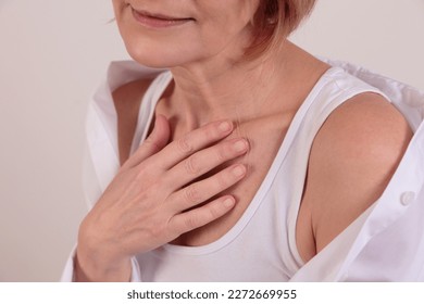Skin Care and Aging. Senior woman gently touching her skin