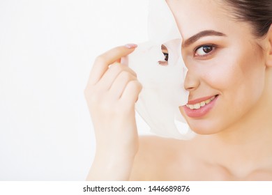Skin Care. Beautiful Girl With Sheet Mask on Her Face