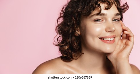 Skin care and beauty. Close up of smiling girl, 25 years face, glowing face after nourishing gel, facial cream, pink background. - Shutterstock ID 2206367839